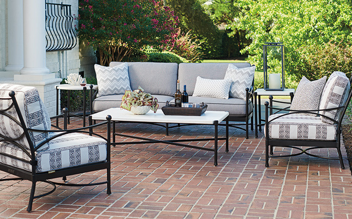 Outdoor living scene featuring sofa and cocktail table.