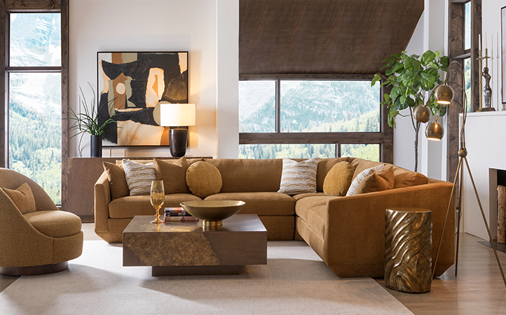 Artistica Upholstery scene featuring a orange brown sectional, brown console, bronze side table and brown cocktail table.