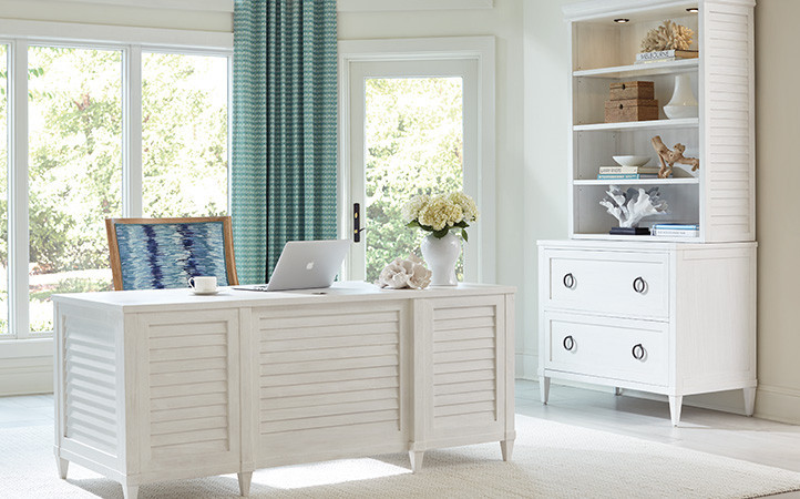 Sanibel home office scene featuring a desk, office chair, and file cabinet with deck.